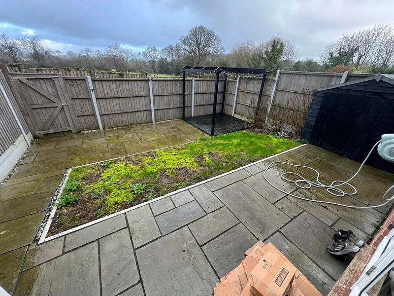 Back garden before a full design and build makeover, with weathered paving, a mossy lawn and old panel fencing